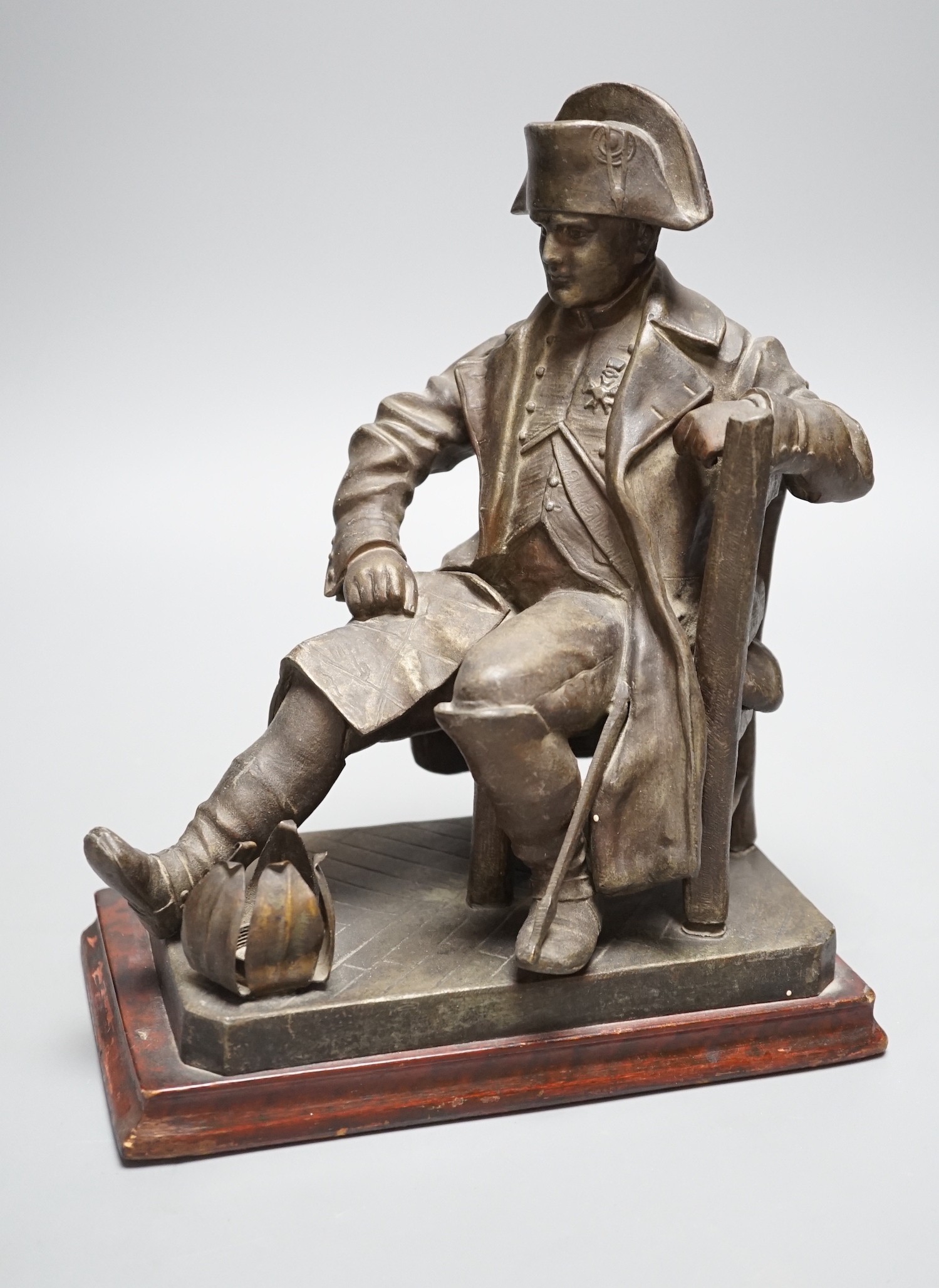 An early 20th century bronzed metal table lamp moulded as Napoleon seated, 26cm